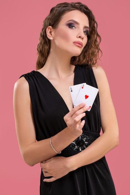 Bella donna caucasica con carte da poker gioco d'azzardo in studio del casinò girato