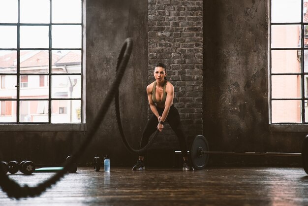 Bella donna che si allena e fa un allenamento funzionale in palestra