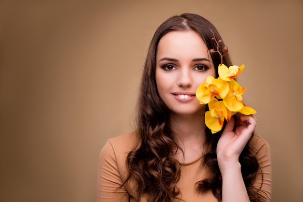 Bella donna con fiore orchidea gialla