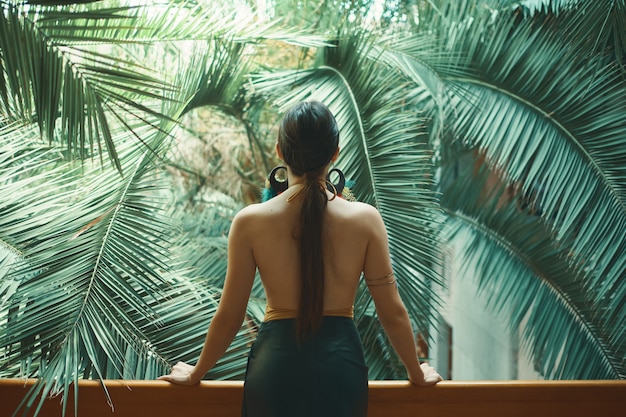 Bella donna esotica che riposa sul balcone mentre sul suo vacat