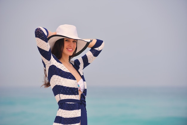 Bella donna felice che gode delle vacanze estive sulla spiaggia