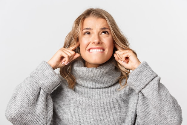 Bella donna in un maglione grigio in posa