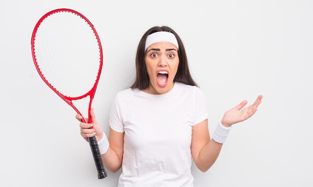 Bella donna ispanica che si sente estremamente scioccata e sorpresa. concetto di tennis