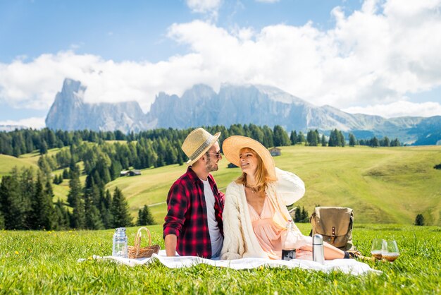 Bella giovane coppia in viaggio e facendo un picnic nelle Dolomiti, Italia