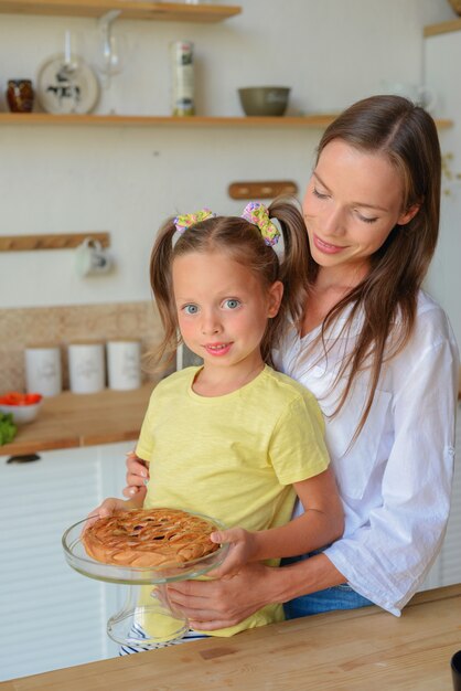 bella giovane donna con sua figlia prepara la colazione in cucina family tea party