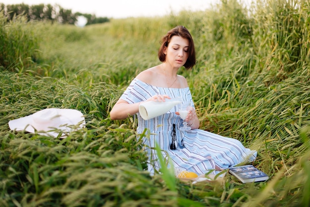 Bella giovane donna in estate in un campo di grano