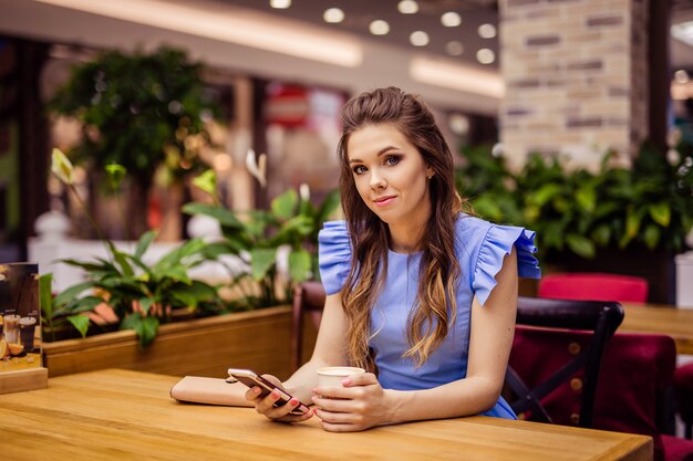 Bella giovane donna in un vestito blu in città