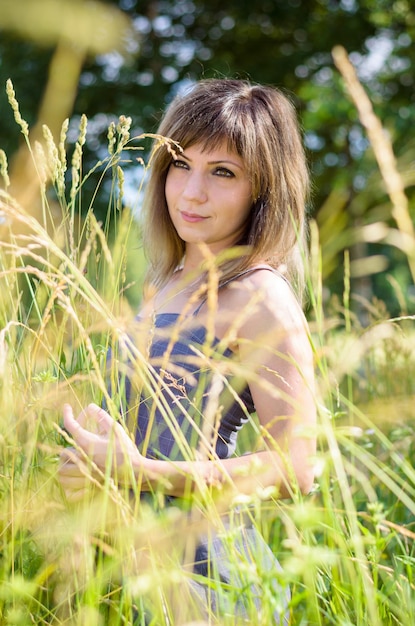 Bella giovane donna nel parco sta riposando in estate