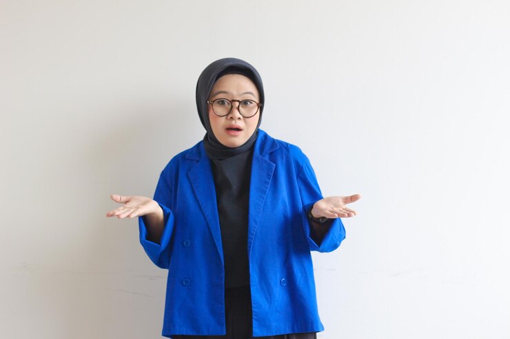 Bella giovane musulmana asiatica che indossa occhiali e blazer blu che mostra le palme
