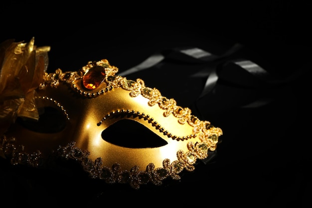 Bella maschera d'oro di carnevale su sfondo nero in primo piano