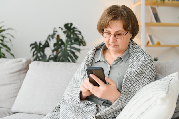 Bella nonna che parla al telefono a casa