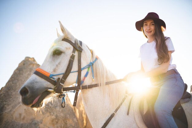 Bella ragazza all'aperto in montagna con il suo fedele cavallo