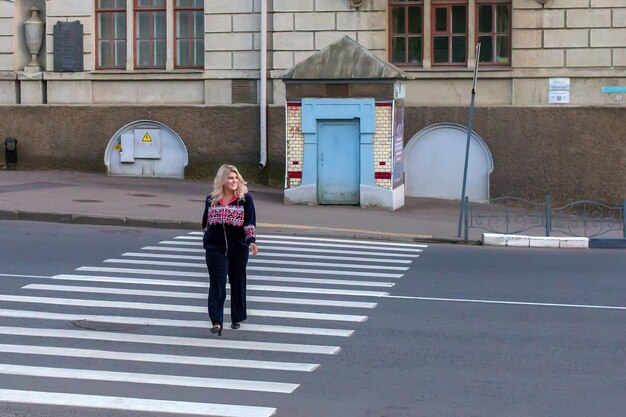 Bella ragazza che cammina su un passaggio pedonale