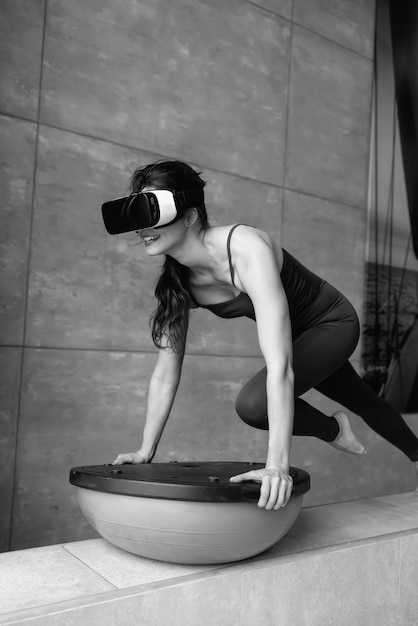 Bella ragazza che fa fitness nell'universo digitale. Forma fisica del futuro. Innovazioni. Virtuale