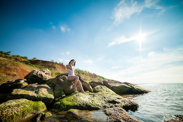 Bella ragazza che prende il sole e nuota nel mare