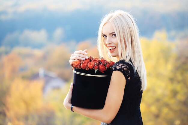 Bella ragazza con fiori in scatola