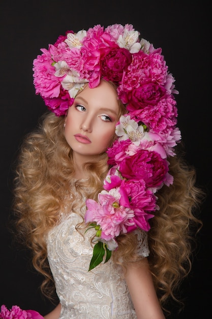 Bella ragazza con le peonie