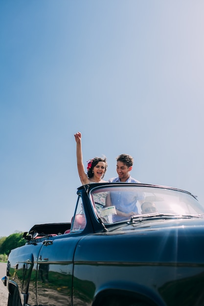 bella ragazza con un ragazzo in una macchina retrò