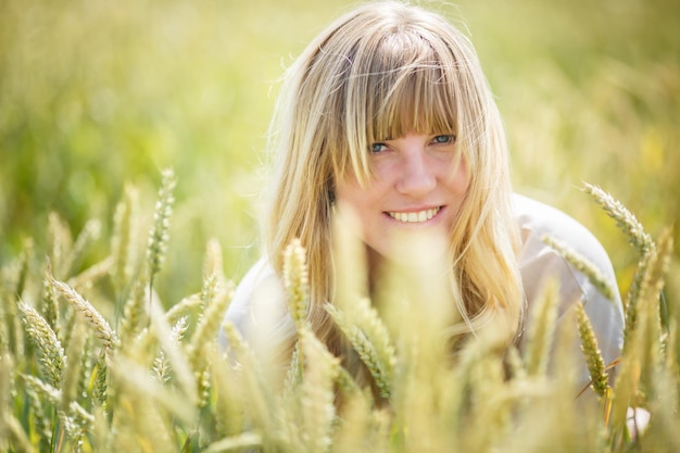 Bella ragazza con un vestito di lino in un campo di grano