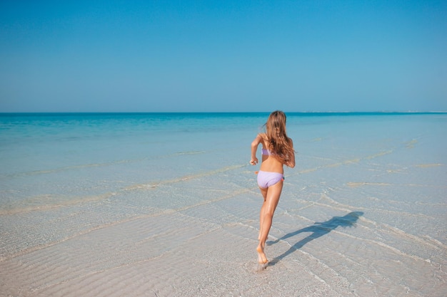 Bella ragazza divertendosi sulla spiaggia tropicale