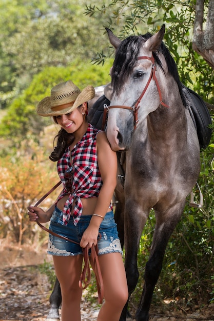 Bella ragazza e cavallo in natura