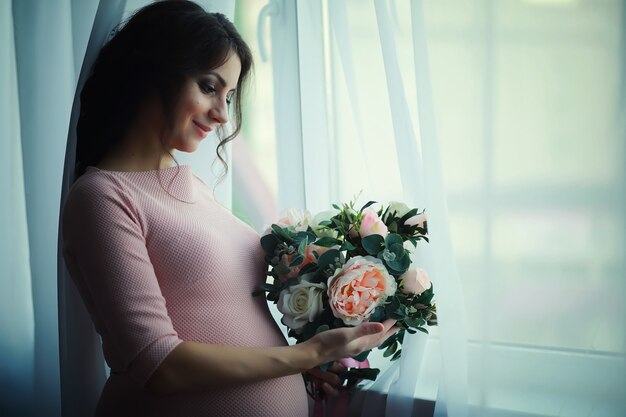 Bella ragazza incinta con una grande pancia. Giovane coppia incinta sposata. Marito con moglie incinta. Una coppia in attesa della nascita di un bambino.