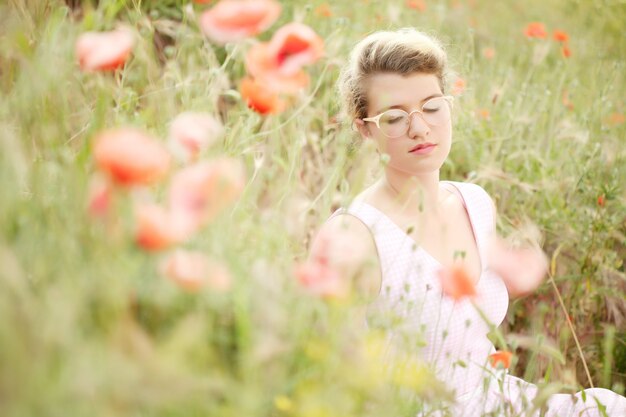 bella ragazza nel campo di papaveri.