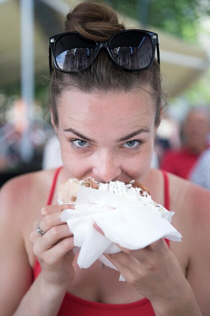 Bella ragazza o donna che mangia giroscopi sandwich Ragazza con piacere mangia hamburger dopo la dieta Ha aperto la bocca tenendo un giroscopio sulle sue mani tese e ha chiuso gli occhi