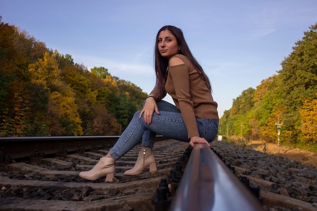 Bella ragazza sul binario ferroviario.