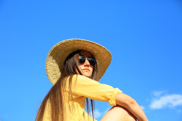 Bella ragazza sullo sfondo del cielo blu