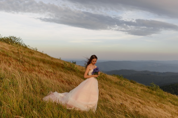 Bella sposa nel suo abito da sposa sulla montagna