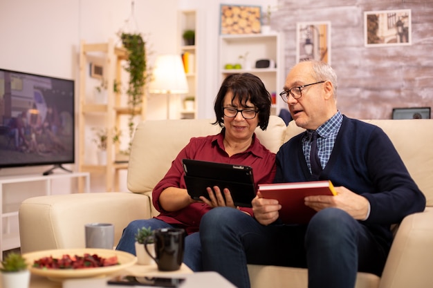 Bella vecchia coppia che utilizza una tavoletta digitale per chattare con la propria famiglia. Anziani che utilizzano la tecnologia moderna