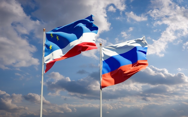 Belle bandiere di stato nazionali della Gagauzia e della Russia insieme sul cielo blu. Grafica 3D