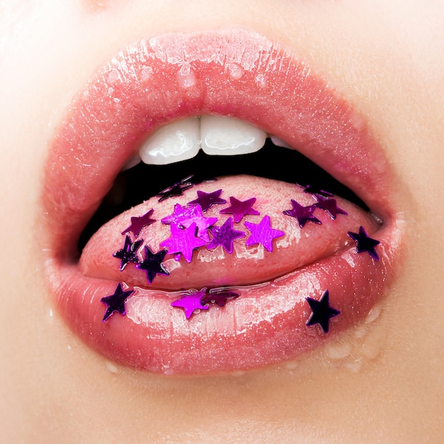 Belle labbra con gocce d'acqua e scintillii sotto forma di stelle da vicino