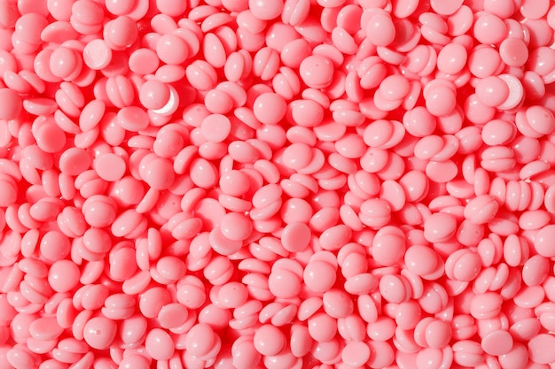 Bellissimi granuli di cera calda per depilazione rosa Trama di sfondo di depilazione con cera depilatoria rosa