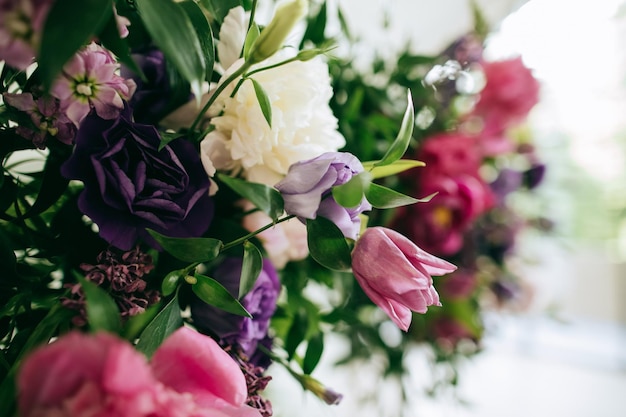 Bellissimo arco nuziale fatto di fiori freschi viola e rosa al ricevimento di nozze