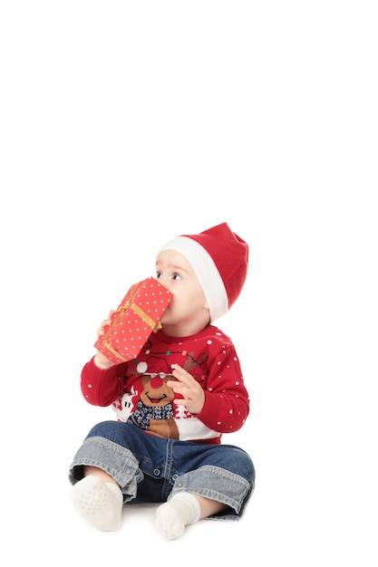 Bellissimo piccolo bambino festeggia il Natale con il regalo isolato