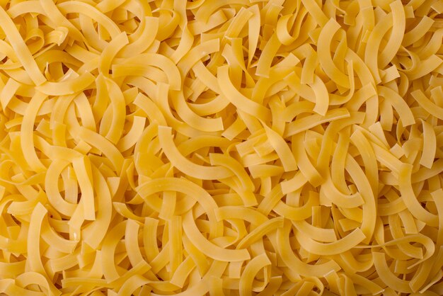 Bello fondo italiano dorato della pasta, bio- alimento