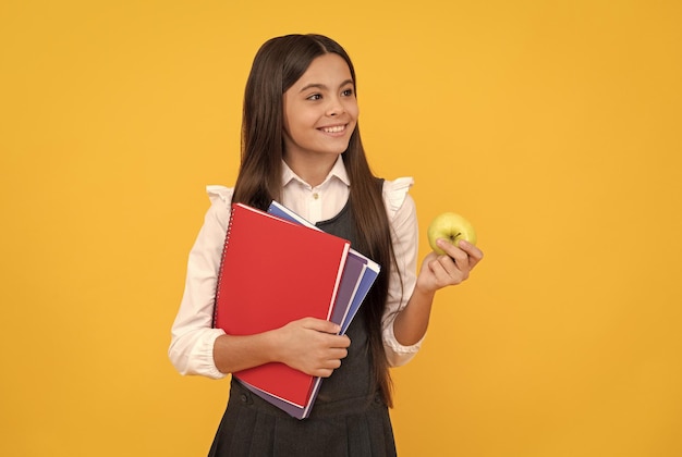 Bentornato a scuola Sorriso felice del bambino che tiene mela e libri Ritorno a scuola Ritorno a scuola