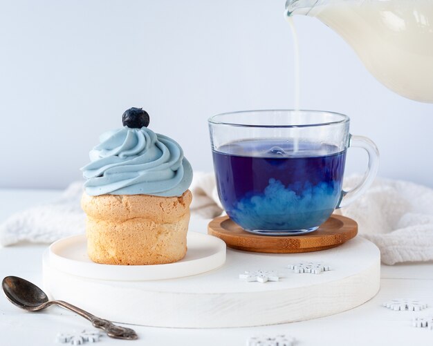 Bevanda blu alla moda dal tè di piselli Butterfly con latte e torta per colazione