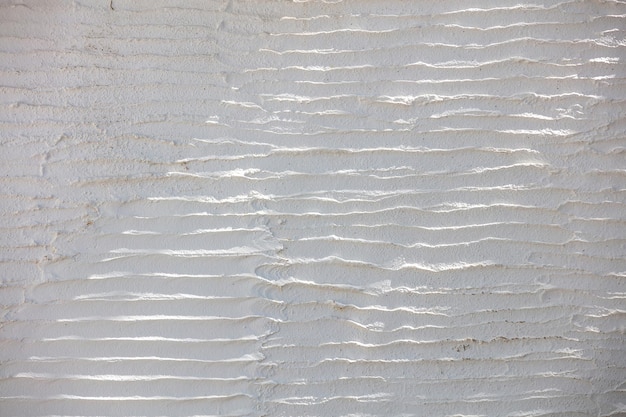 Bianco ondulato intonacato muro vuoto texture di sfondo Grecia Cicladi isola decorazione Copia spazio