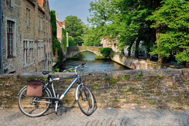 Bicyccle su un ponte vicino al canale e alle vecchie case. Bruges Bruges, Belgio