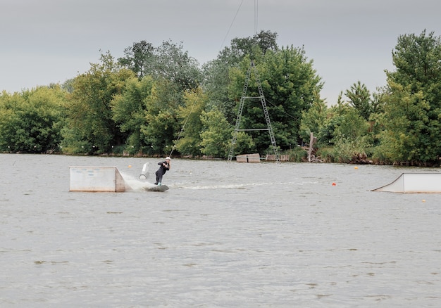 Bielawa, Polonia. 03/06/2020 Wawa Wake. Giovane atleta femminile scivola sugli sci d'acqua sulle onde del lago. Ragazza che cavalca il Wakeboard