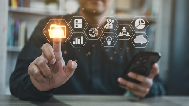 Big data cloud computing database document management system businessman hold mobile use finger point folder and goal document icon software network searching manage files online document database