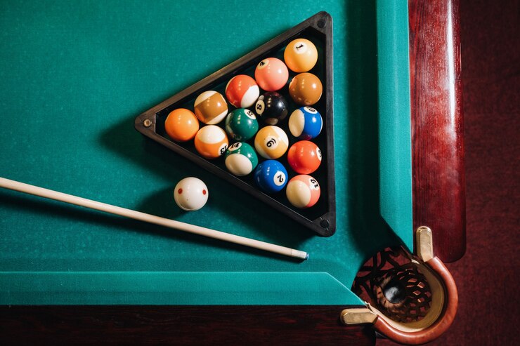 Billiard table with green surface and balls in the billiard club. Pool Game.