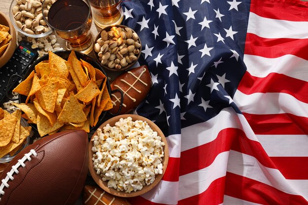 Birra con snack, un pallone da rugby e una bandiera americana