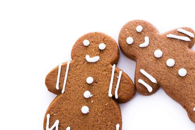 Biscotti fatti in casa di panpepato decorati con glassa bianca su sfondo bianco.