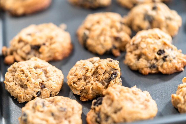 Biscotti gommosi all'uvetta di farina d'avena appena sfornati su una teglia da forno.