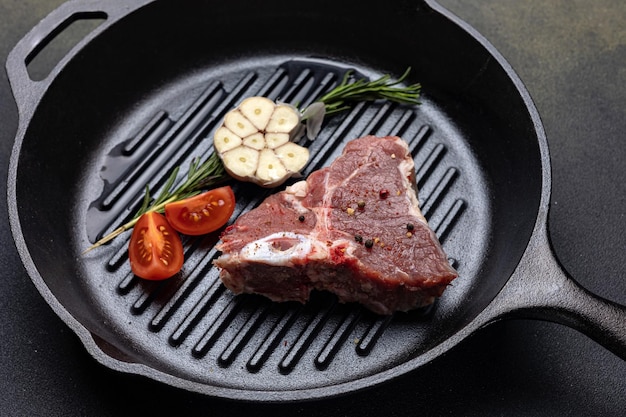 bistecca cruda con spezie in una padella di ghisa