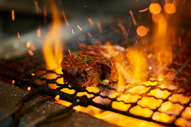 Bistecca di carne cruda sulla griglia con fuoco